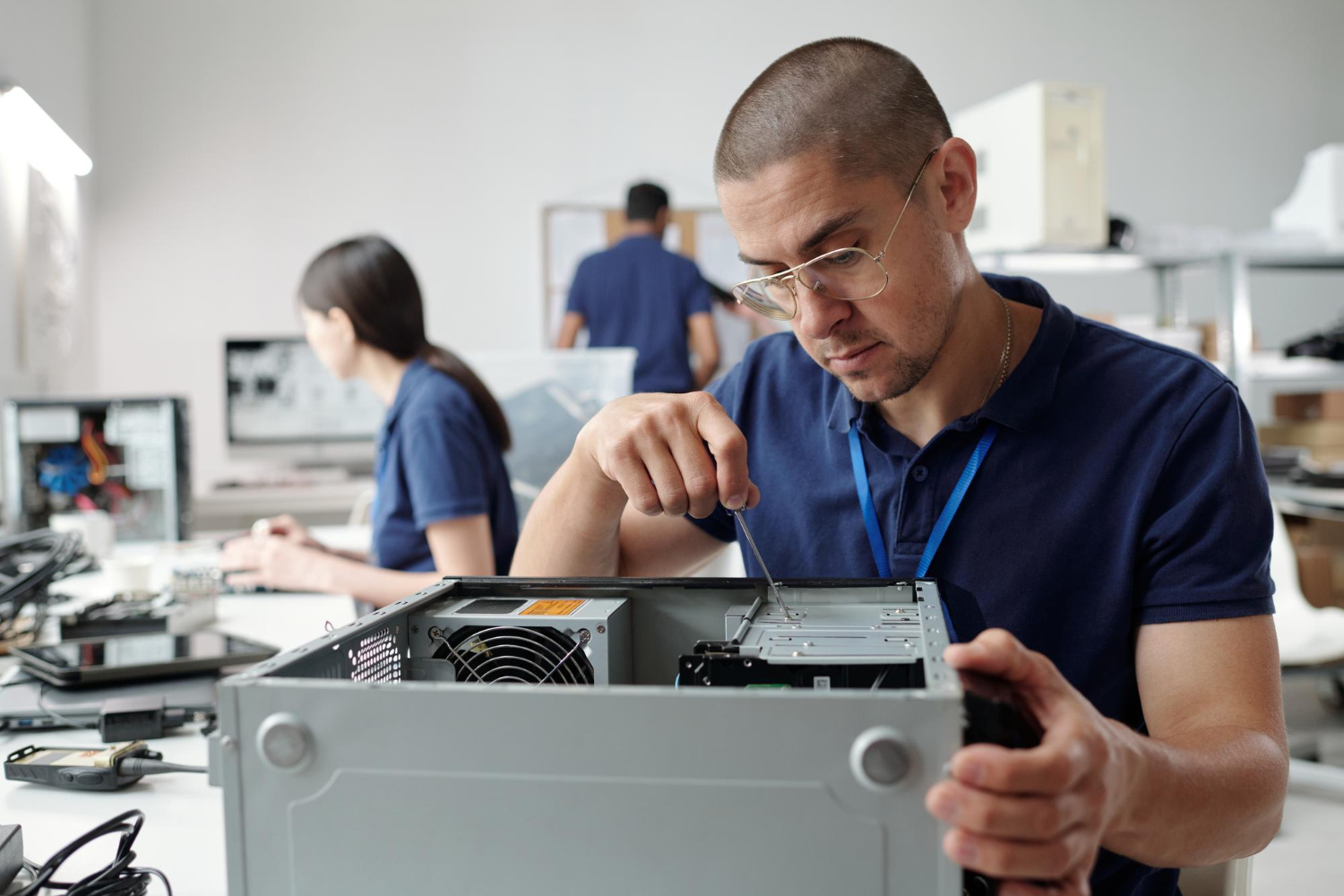 Technician hands-on repairing a small business desktop computer